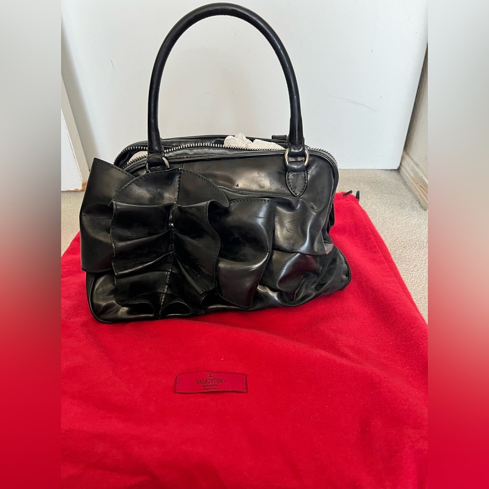 Valentino Garavani black patent leather bag.